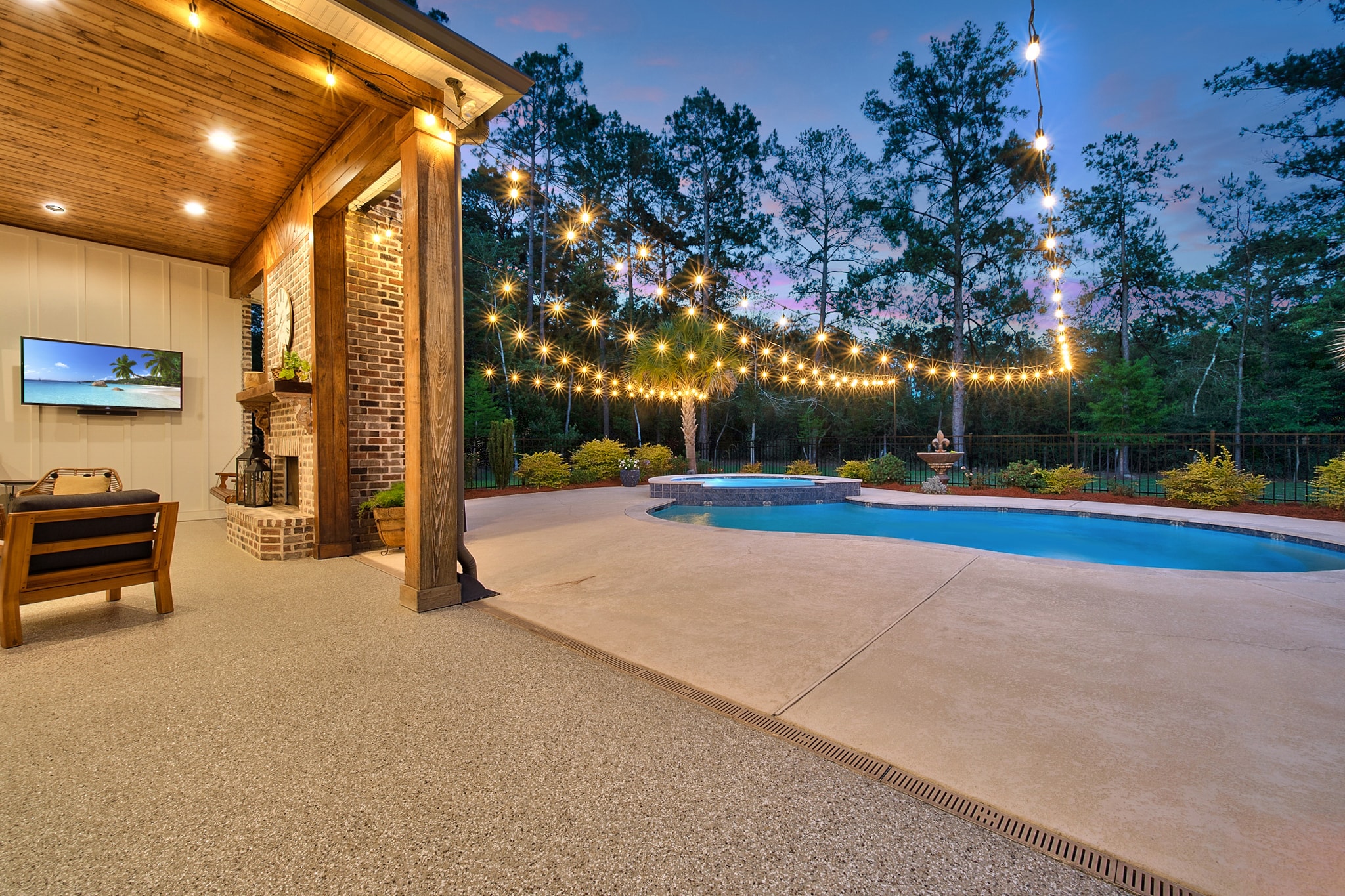 Backyard pool and patio with string lights